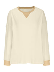 Cream waffle knit raglan sleeve sweatshirt with tan neckline and cuffs.