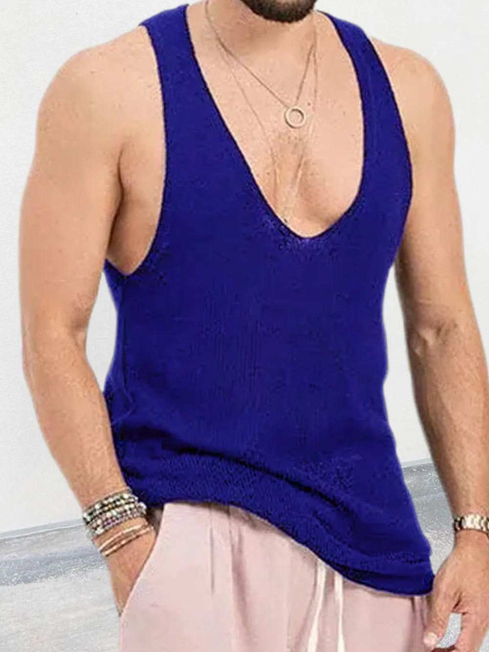 Deep plunge knit tank top in blue with a low neckline and ribbed texture.