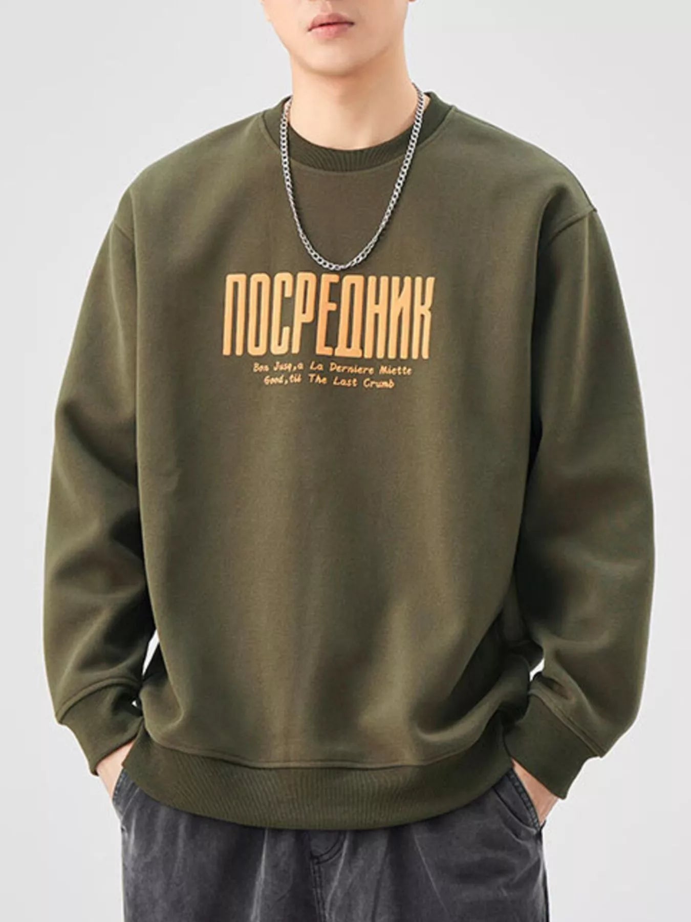 Oversized graphic sweatshirt in Army Green cotton blend with crewneck and text graphic.