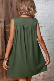 Army green viscose trapeze dress with gathered yoke detail and sleeveless design.
