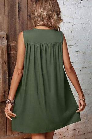Army green viscose trapeze dress with gathered yoke detail and sleeveless design.