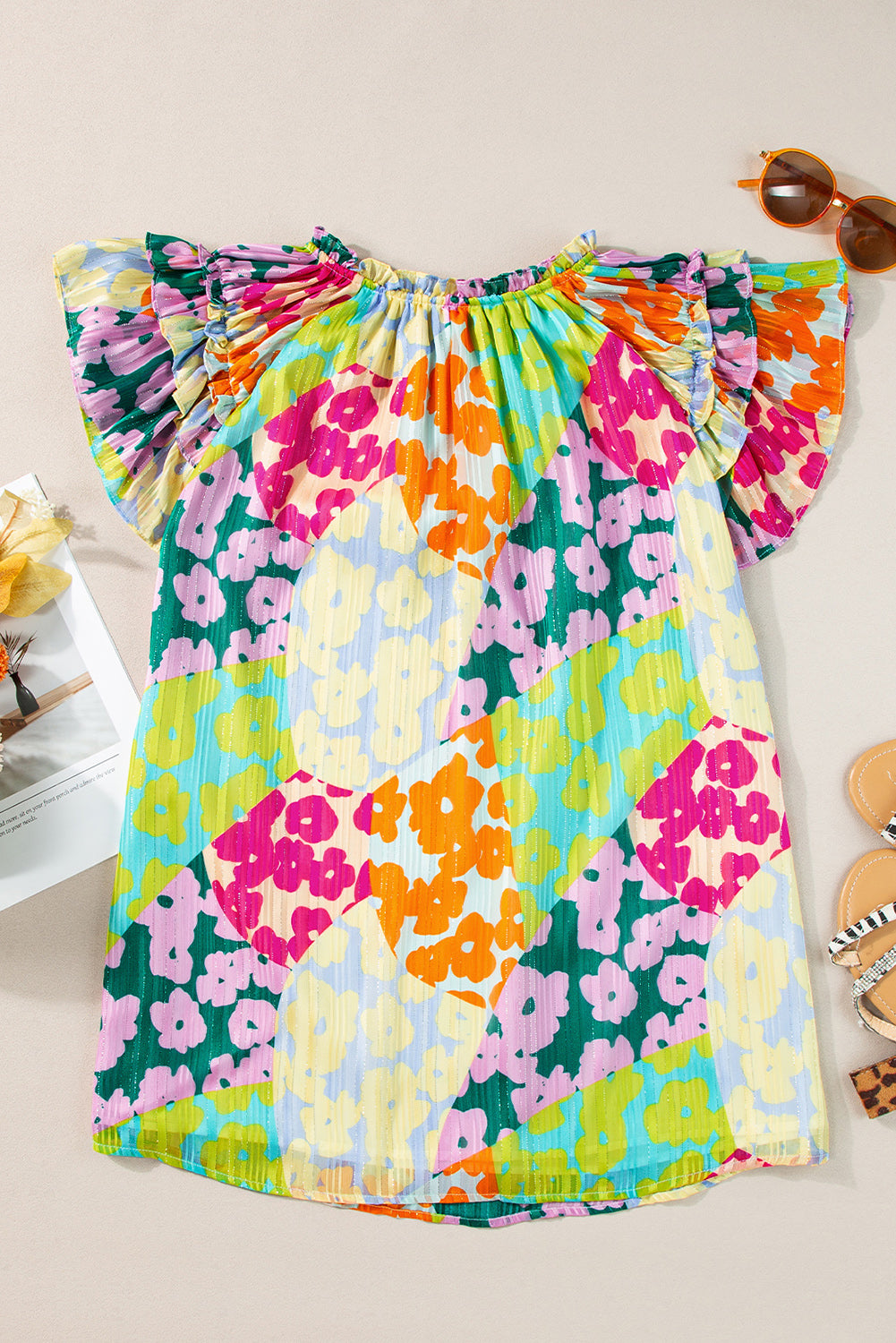 Floral patchwork ruffle sleeve blouse with a smocked neckline in vibrant colors.
