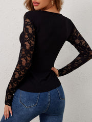 Black ribbed top with long lace sleeves and scalloped cuffs.