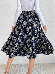 Navy floral print midi skirt with tiered hem and ruffled detail.