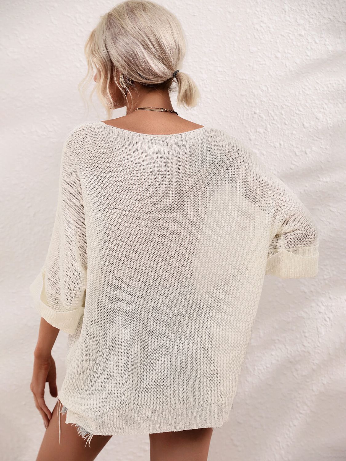 Ivory relaxed knit tunic top with boat neck and cuffed sleeves.