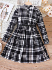 Black and white plaid long-sleeve belted dress with a high neckline and flared skirt.