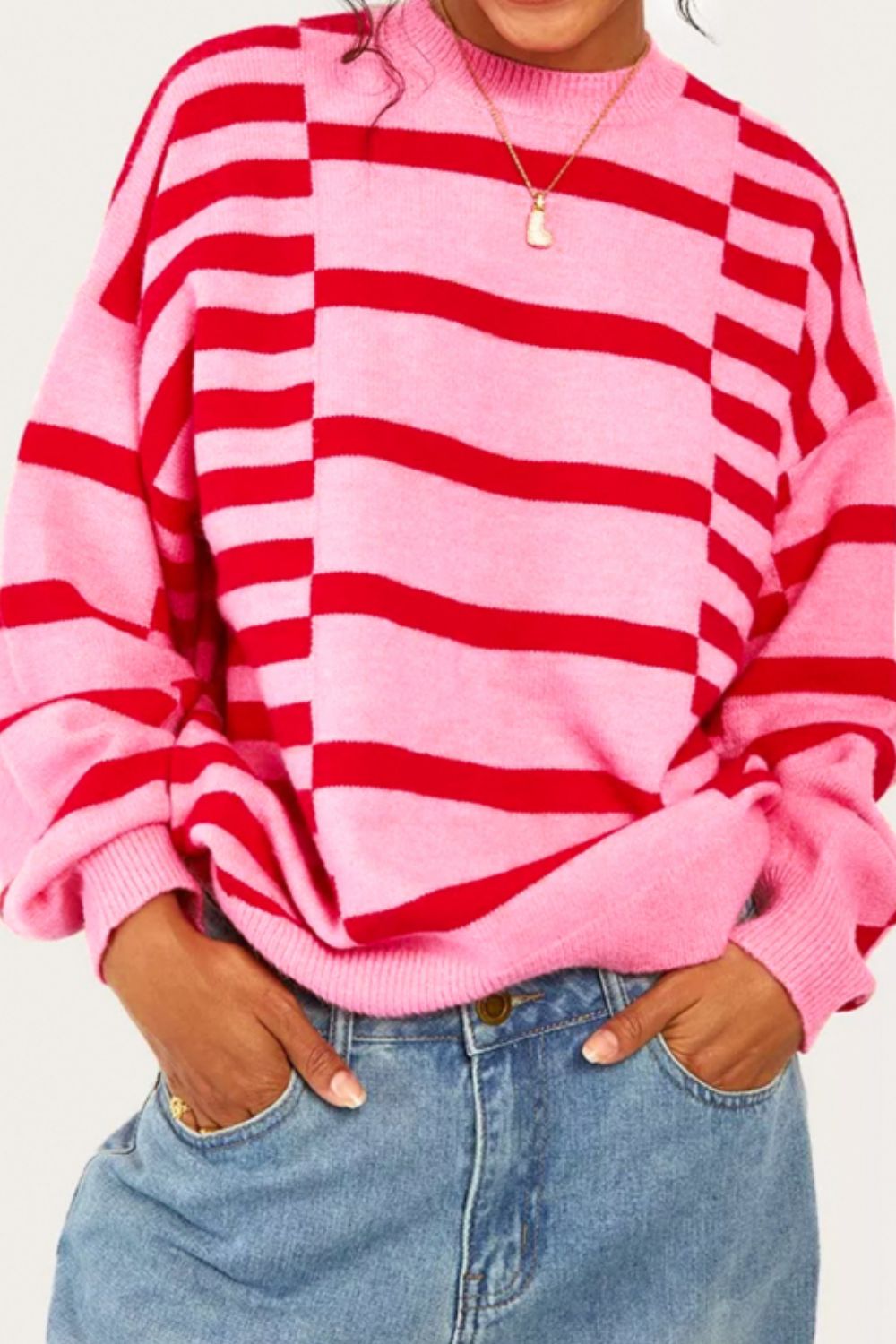 Colorblock stripe knit sweater in hot pink with balloon sleeves and crew neck.