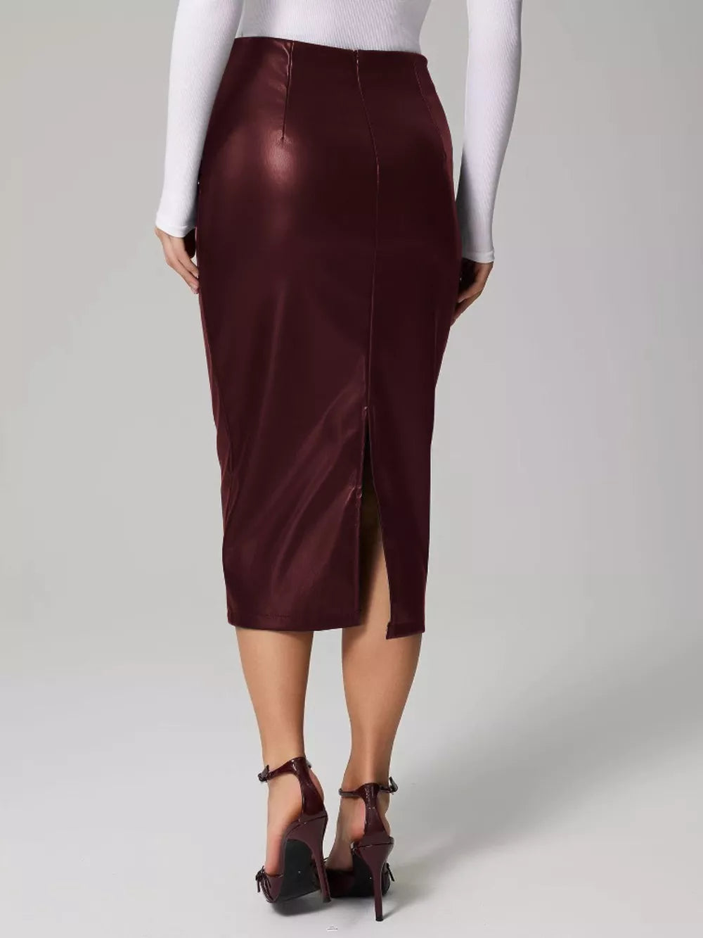 Burgundy leather midi skirt with back slit and high waist.
