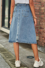 A-line denim midi skirt in medium wash with button detail and back pockets.
