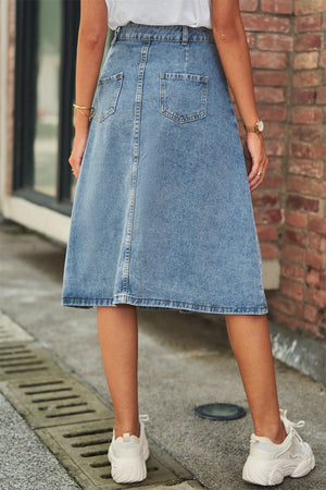 A-line denim midi skirt in medium wash with button detail and back pockets.