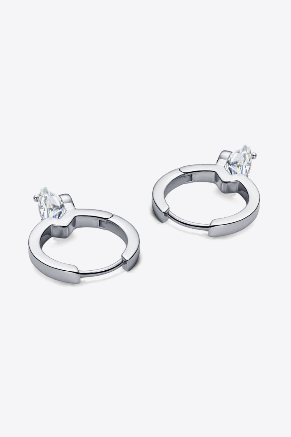 Silver huggie hoop earrings with a single marquise-cut gemstone accent.