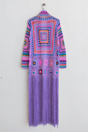 Lilac granny square crochet duster with multicolor details and long fringe.
