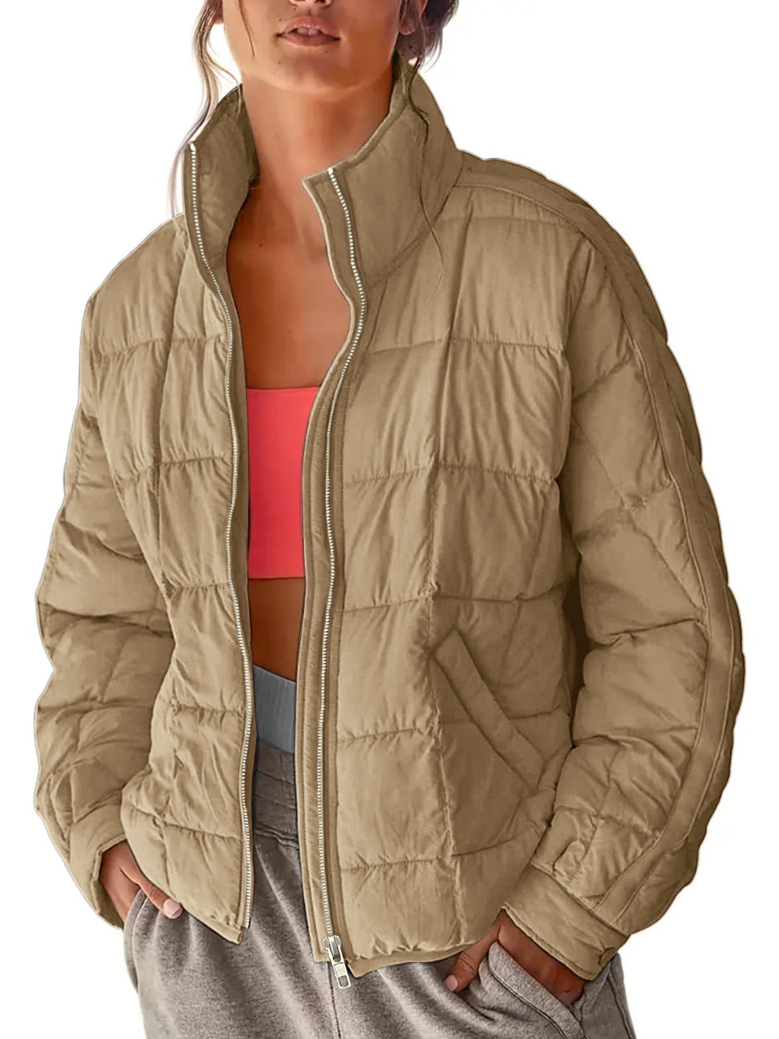 Quilted bomber jacket in camel with stand collar and zip closure.