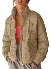 Quilted bomber jacket in camel with stand collar and zip closure.