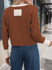 Brown raglan sleeve knit cardigan with cream trim and a cream patch on the back.