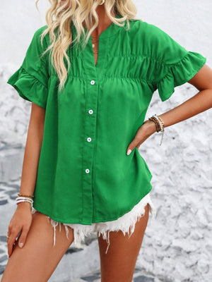 Green button-up blouse with gathered yoke and ruffle sleeves.