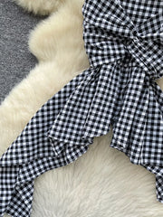 Black and white gingham cami top with twisted knot detail and asymmetrical hem.