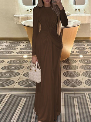 Brown ruched knot front maxi dress with long sleeves and a crew neckline.