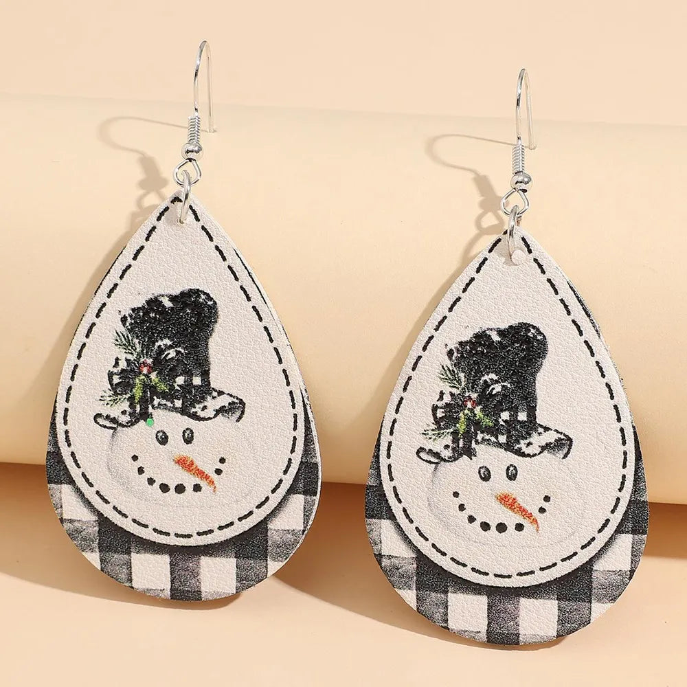 Festive snowman drop earrings with buffalo check pattern and black hat detail.