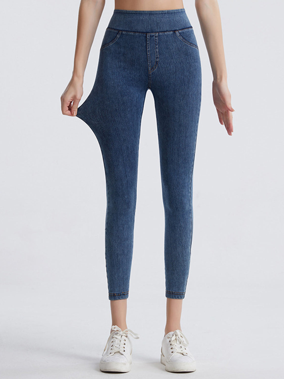 Denim illusion leggings in medium wash with faux pockets and a stretchy waistband.