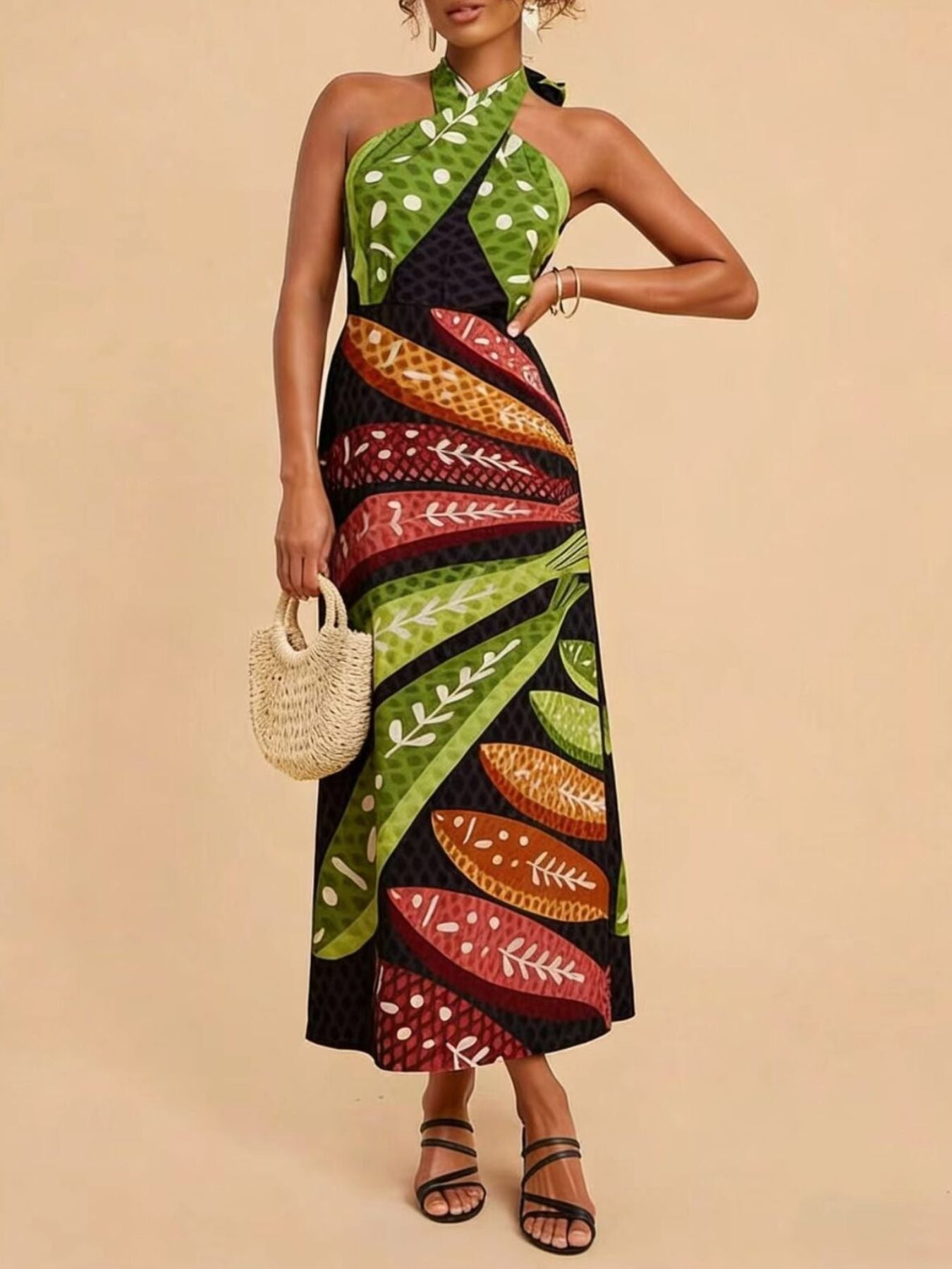Tropical print halter neck midi dress with green polka dot and leaf patterns.