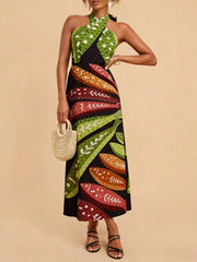 Tropical print halter neck midi dress with green polka dot and leaf patterns.