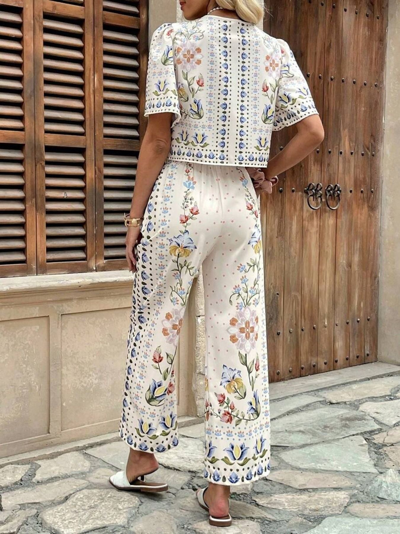 Floral tie-front cropped top and wide-leg pants set with puff sleeves.