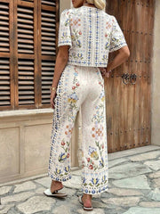 Floral tie-front cropped top and wide-leg pants set with puff sleeves.