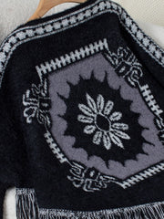Black acrylic poncho with Aztec motif and fringe detail