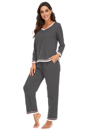 Charcoal V-neck long sleeve pajama set with contrast trim on neckline, cuffs, and hem.