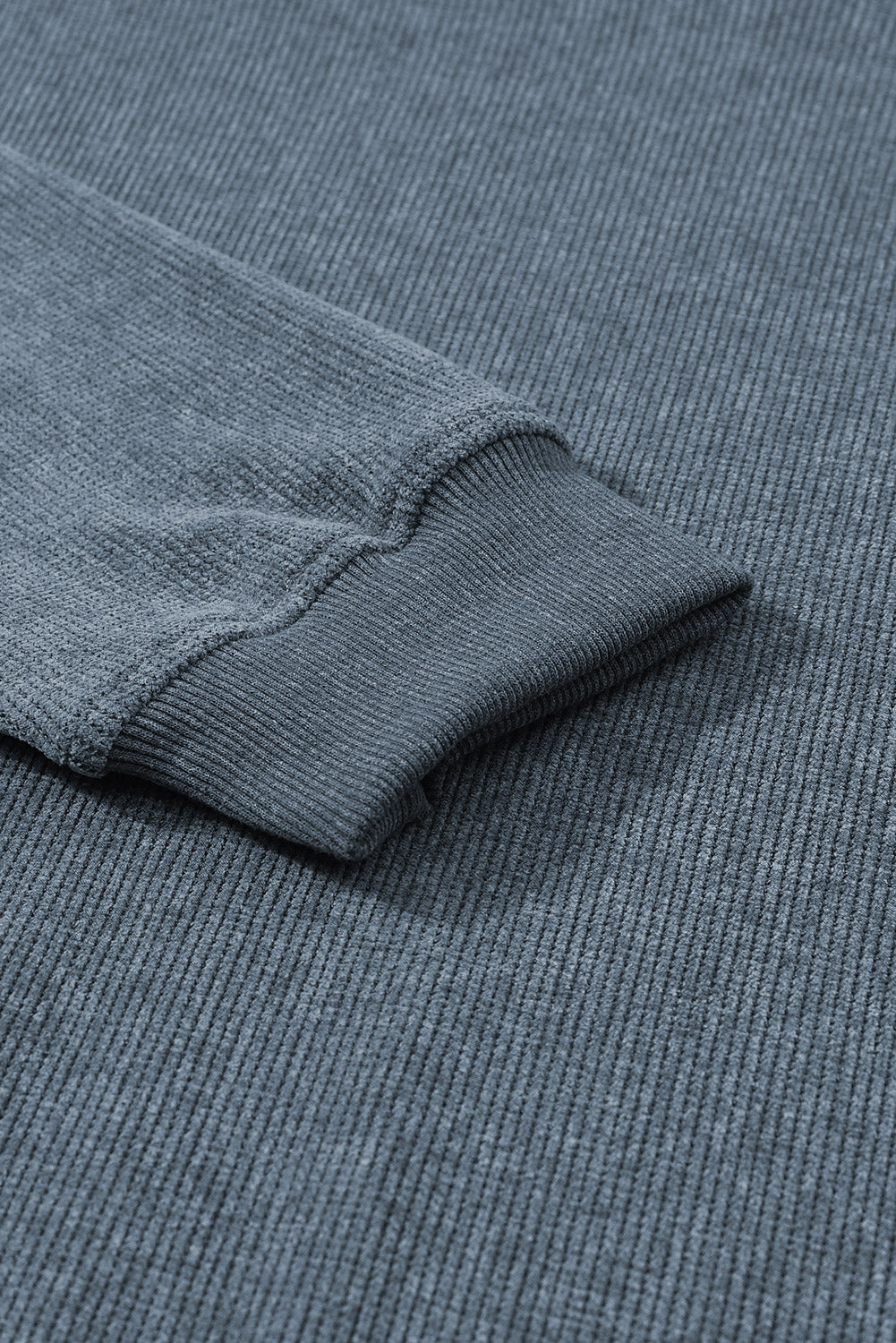 Textured ribbed crewneck pullover in Dusty Blue with ribbed cuffs and hem detail.