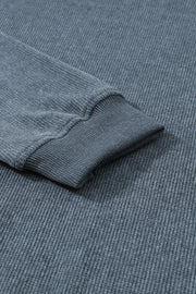 Textured ribbed crewneck pullover in Dusty Blue with ribbed cuffs and hem detail.