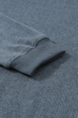 Textured ribbed crewneck pullover in Dusty Blue with ribbed cuffs and hem detail.