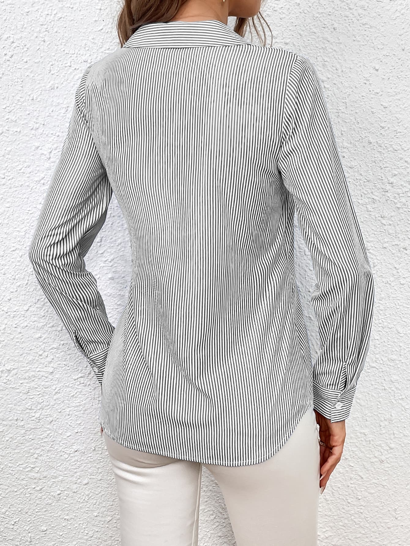 Gray striped wrap-front blouse with button cuffs and a bow detail.
