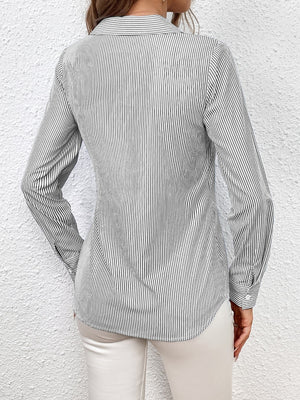 Gray striped wrap-front blouse with button cuffs and a bow detail.