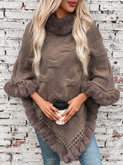 Mocha cable knit poncho with faux fur trim and turtleneck, styled with jeans.