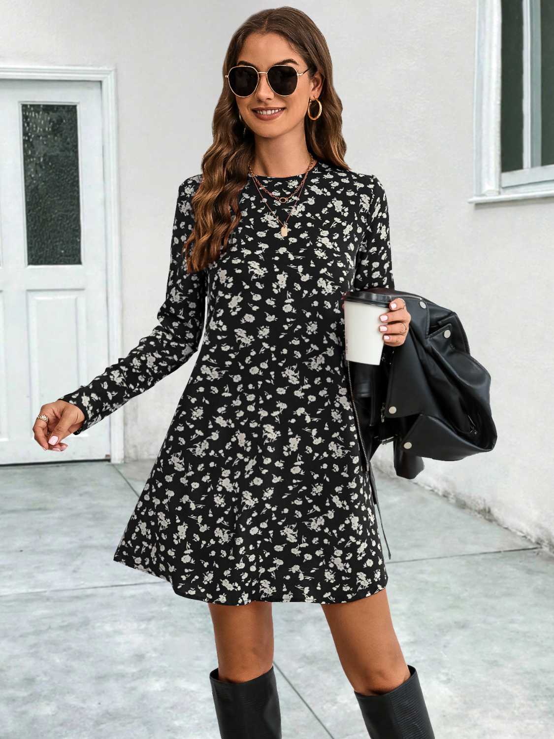 Black floral swing mini dress with long sleeves and crew neck.