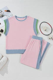 Ribbed blush pink loungewear set with blue and green trim. Sleeveless top and pants.