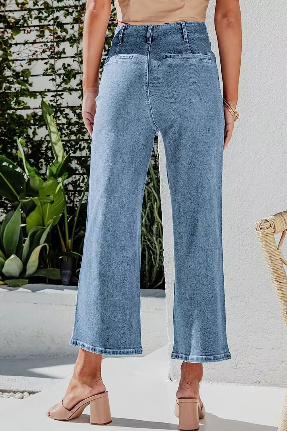 Button-front cropped wide-leg jeans in light blue denim with a relaxed fit.