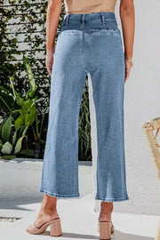 Button-front cropped wide-leg jeans in light blue denim with a relaxed fit.