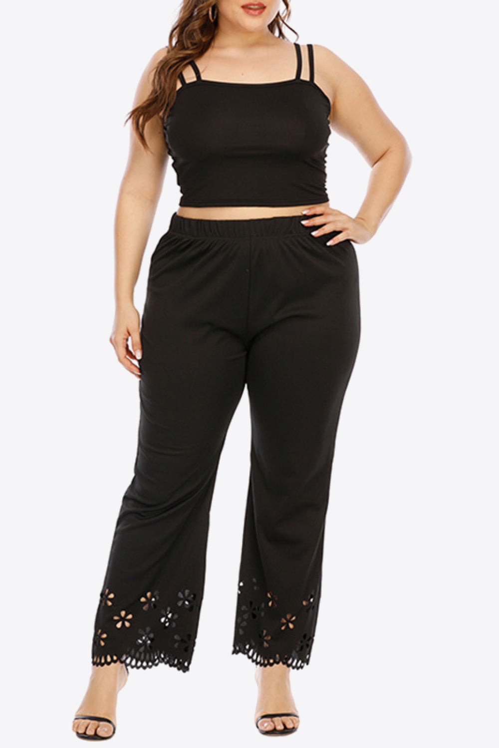 Black flare trousers with floral cutout hemline detail