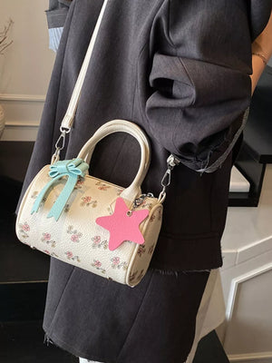 Charming floral mini crossbody bag with blue bow and pink star charm