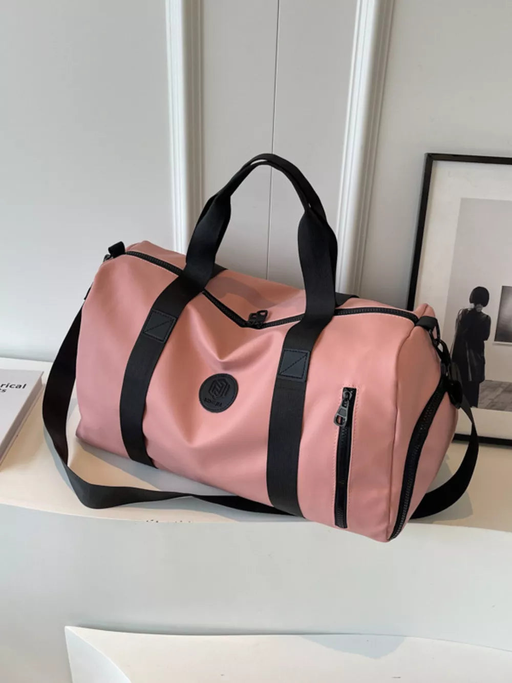 Pink travel organizer bag with black straps and adjustable shoulder strap