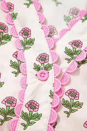 Floral V-neck midi dress with pink scalloped trim and button front.