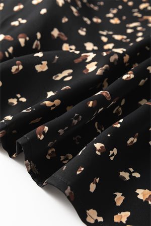 Black high-neck blouse with abstract print and draped fabric detail