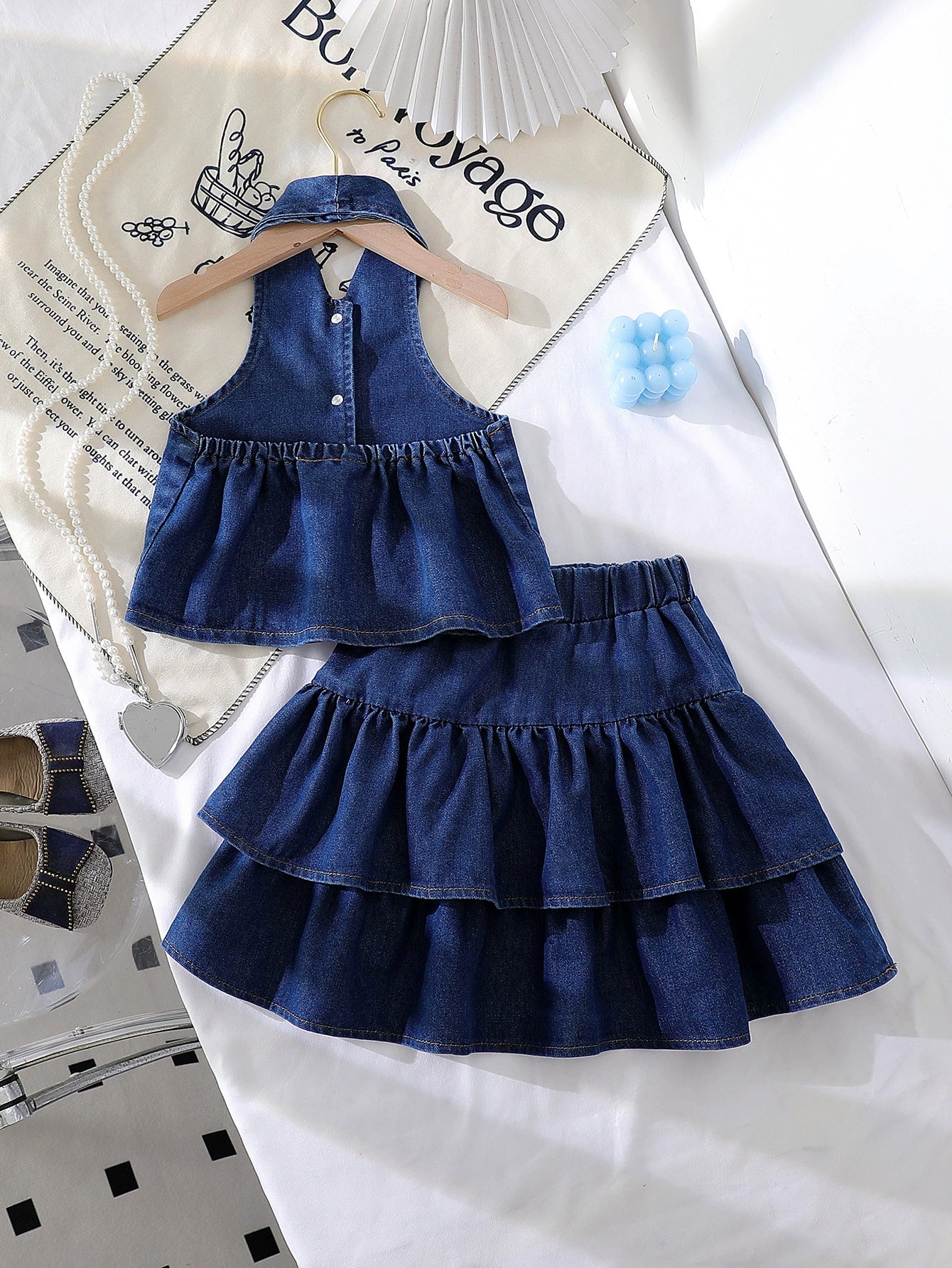 Denim halter top and tiered skirt set with bow accents in dark navy.