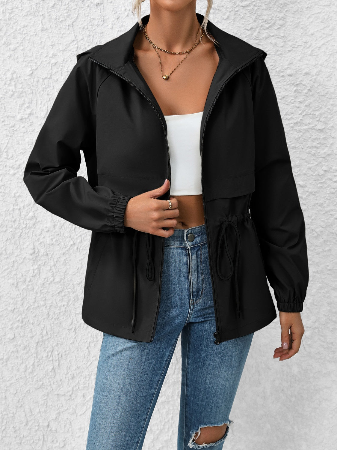 Black hooded utility jacket with cinched waist and elastic cuffs.