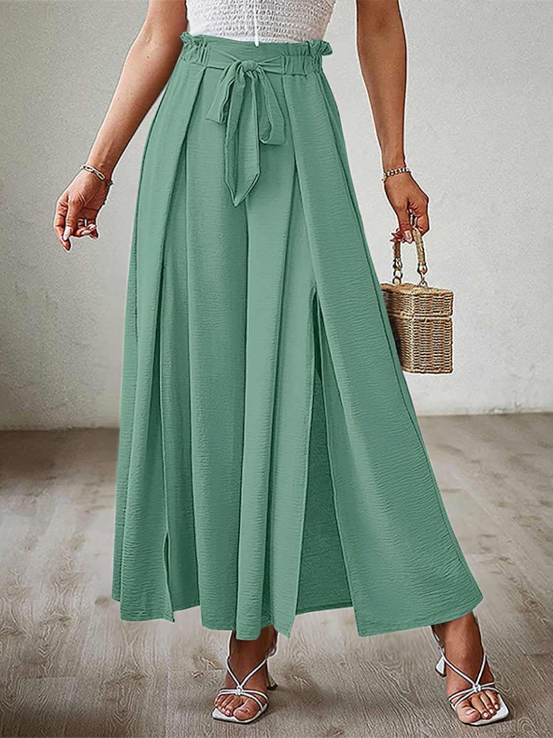 Matcha green paperbag waist palazzo pants with side slits and tie belt.