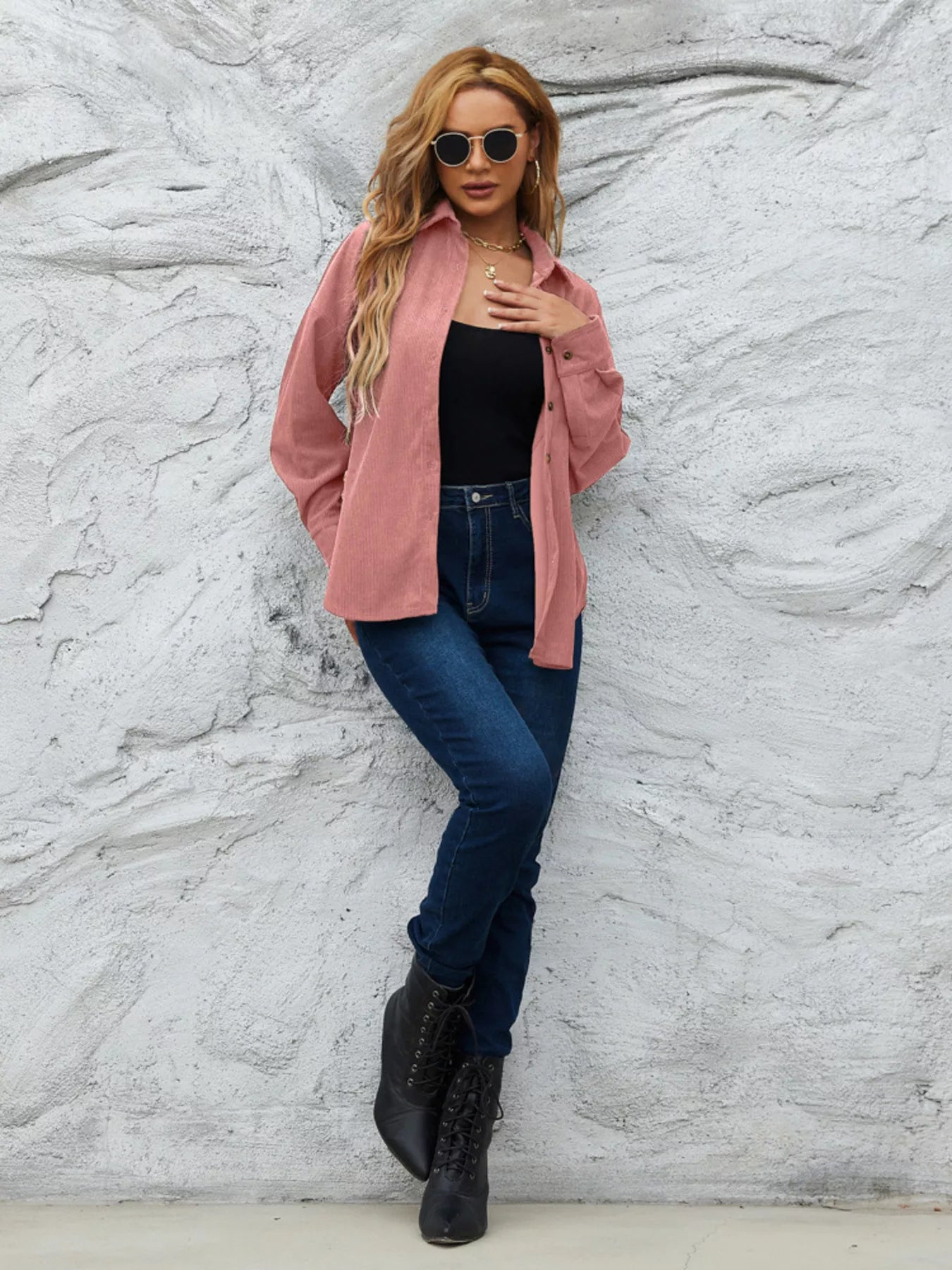 Pinkish corduroy button-up shirt with collar and long sleeves, styled open over a black tank top.