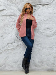 Pinkish corduroy button-up shirt with collar and long sleeves, styled open over a black tank top.